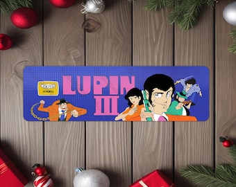 May include: A blue and pink rectangular sign with the text "Lupin III" and an image of four cartoon characters. The characters are wearing colourful outfits and are holding weapons. The sign has a yellow box with the text "Taito Electronics" in the top left corner.