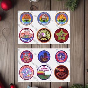 May include: A collection of colorful, circular patches with various designs and text. The patches feature images of cartoon characters, logos, and text such as "Decathlon," "Spider Fighters," and "Space Shuttle Pilot." The patches are arranged on a wooden surface.