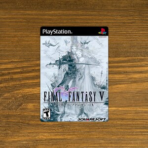 May include: PlayStation game case for Final Fantasy V, featuring a black and white illustration of a knight and a woman in a flowing dress. The text "FINAL FANTASY V" is in a purple font with a pink and purple background. The game is rated "Teen" by the ESRB.