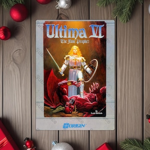 May include: A vintage video game cartridge for Ultima VI: The False Prophet. The cover art features a knight with a sword and shield standing over a red demon. The Origin logo is visible at the bottom. The cartridge is surrounded by Christmas decorations.