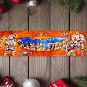 May include: A rectangular sign with the text "SLAM MASTERS" in blue 3D letters, surrounded by muscular cartoon figures. The sign has an orange background with the text "CAPCOM SATURDAY NIGHT".