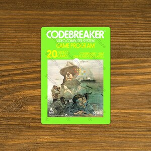 May include: A vintage Atari Codebreaker video game cartridge. The bright green label features the game title, "CODEBREAKER," and a graphic of a man in a hat. The label also includes the text "20 VIDEO GAMES ONE PLAYER-TWO PLAYERS."