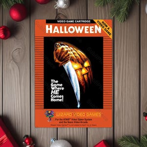 May include: A vintage Halloween video game cartridge with an orange and black design. The cartridge features a pumpkin with a knife and the text "The Game Where HE Comes Home!" surrounded by holiday decorations.