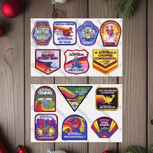 May include: A collection of 12 colorful vintage-style patches featuring the word "Activision" and various team names, including "Ski Team", "Chopper Commandos", "Tennis", "Crackpots", and "Megamanics".