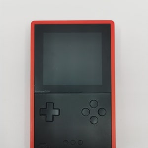 Black Analogue Pocket with a red protective cover made out of hard plastic