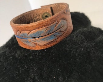 Ogallala Bound, feather leather bracelet, hand stamped and hand painted