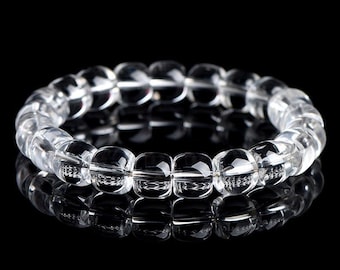 May include: A clear crystal bracelet with square-shaped beads. The bracelet is made of natural quartz and is designed to be worn on the wrist.
