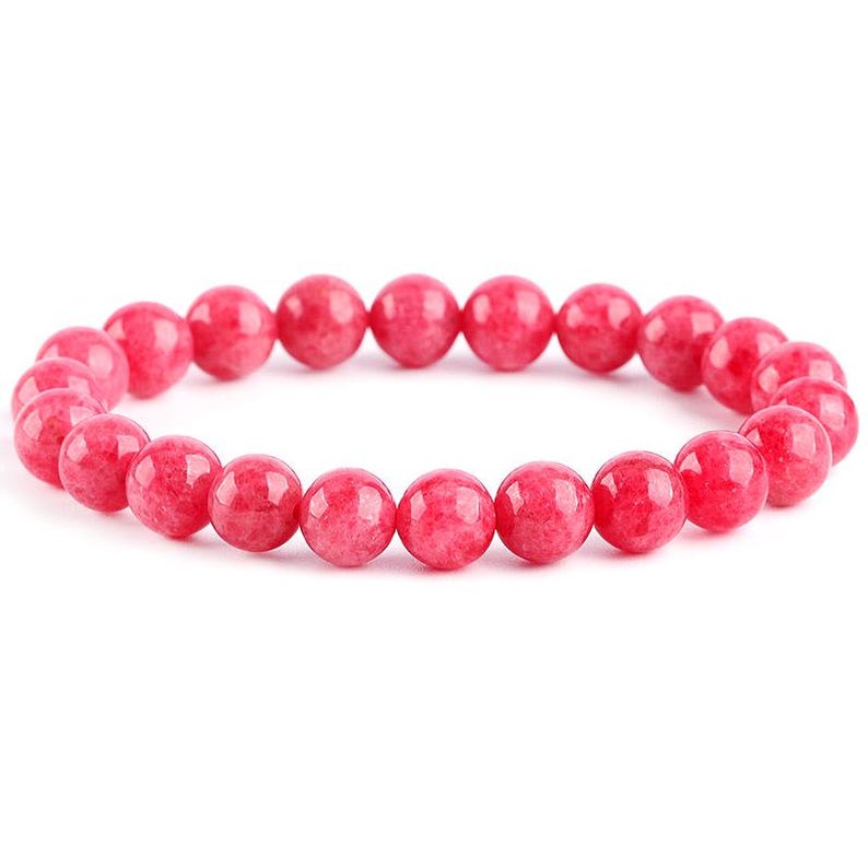 May include: A pink gemstone bracelet with round beads.