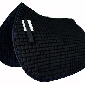 May include: Black quilted English saddle pad with a diamond pattern. The pad has a navy blue trim and a black strap with a tag attached. This equestrian item is designed to provide comfort and protection for the horse.