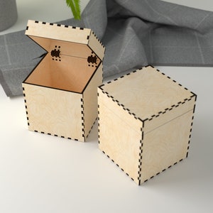 May include: Two wooden boxes with a black dashed line design. One box is open and the other is closed.