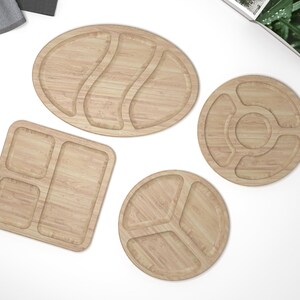 May include: Four wooden serving trays with different shapes and compartment configurations. The trays are made of light brown wood and have a natural wood grain finish.