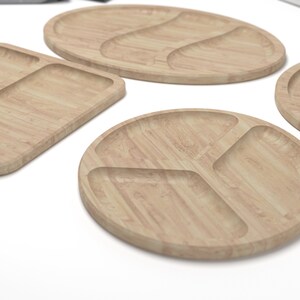 May include: Four wooden serving trays with different shapes and compartment configurations. The trays are made of light brown wood with a natural grain pattern.