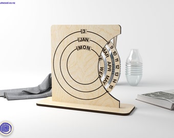 May include: A wooden perpetual calendar with a circular design. The calendar features the months of January, March, April, and May. The numbers 3 through 15 are visible on the calendar.