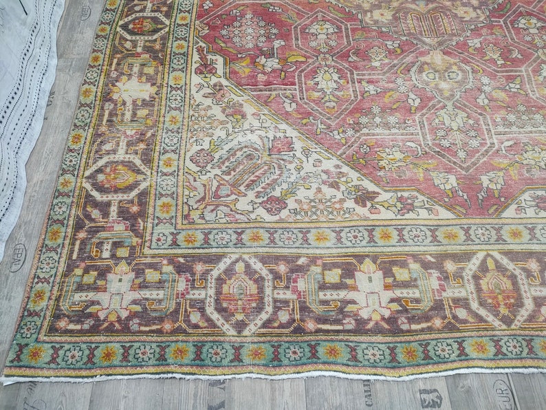 May include: A vintage rug with a red, white, and blue color scheme. The rug has a geometric pattern with intricate details. The rug is in good condition and has a worn look.