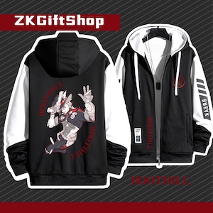 May include: Black and white hooded sweatshirt with a graphic print of a character from the video game "Overwatch." The character is wearing a cowboy hat and holding a gun. The text "BREAK THE LAW" is printed on the back of the sweatshirt.