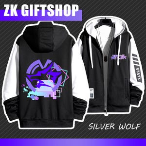 May include: Black and white zip-up hoodie with a purple wolf graphic on the back and the text "Silver Wolf". The hoodie has white sleeves and a black hood. The front of the hoodie has a small graphic and the text "VBEK".
