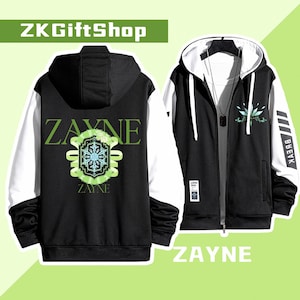 May include: Black and white zippered hoodie with green accents. The front of the hoodie features the word "ZAYNE" in large white letters with a green snowflake design. The back of the hoodie has a green and white design with the word "ZAYNE" in white letters.
