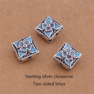 Puede incluir: Tres cuentas cuadradas de plata con diseños de flores de loto en cloisonné azul y marrón. Lotus de dos caras en cloisonné de plata.