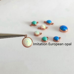 May include: Assortment of imitation European opal beads in white and blue colors. The beads are round and have a smooth, polished finish. The beads are attached to a metal loop, making them easy to add to jewelry projects.