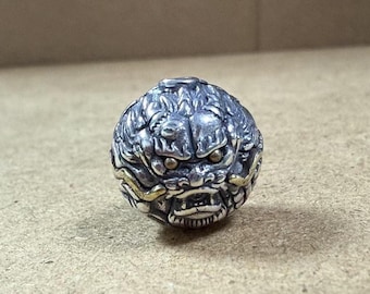 May include: A silver and gold ring with a detailed dragon head design. The dragon's eyes are inlaid with gold.