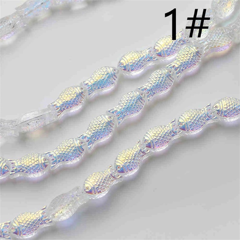 May include: A strand of iridescent glass beads shaped like fish. The beads are strung on a clear thread and have a subtle shimmer. The image includes the number "1#" in the top right corner.