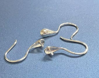 May include: Two silver earring hooks with a teardrop-shaped loop at the top. The hooks are marked with "925" indicating they are made of sterling silver.