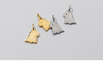May include: Three small dinosaur charms, two gold and one silver, with a simple design. The charms are perfect for adding a playful touch to jewelry.