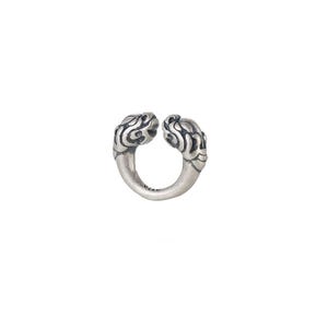May include: An open-ended silver ring featuring two sculpted animal head terminals facing each other. The metal has an oxidized finish with dark recessed details highlighting the intricate textures of the heads and the smooth, curved band.