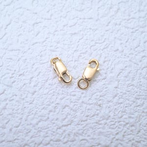 Cierre rectangular de gatillo chapado en oro de 14 quilates con anilla de salto.