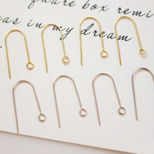 May include: A set of 10 earring hooks, 5 gold and 5 silver. The hooks are made of metal and have a simple, classic design.