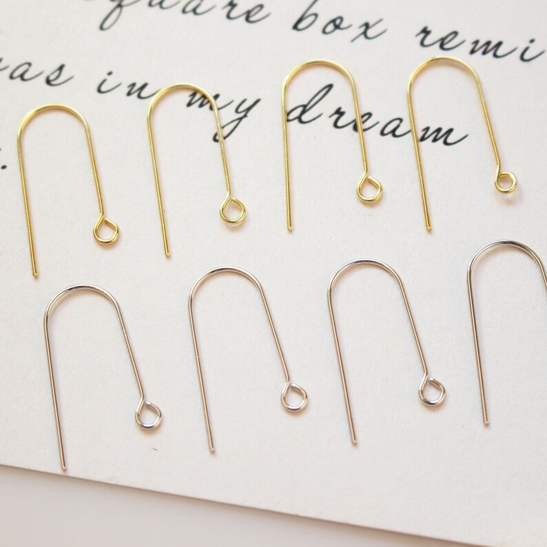 May include: A set of 10 earring hooks, 5 gold and 5 silver. The hooks are made of metal and have a simple, classic design.