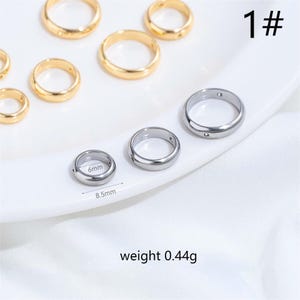 May include: An assortment of gold and silver-colored rings, some with small holes. One ring is measured at 6mm in diameter and 8.5mm in length. The weight of the rings is 0.44g. The number "1#" is in the upper right corner.