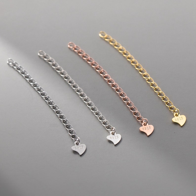 May include: Three silver chain extenders with heart-shaped charms. Each charm is engraved with "925".