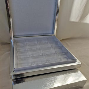 Caja de 16 bombones plateados.