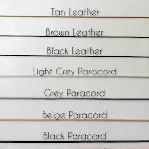 May include: A selection of cords in various colors, including tan, brown, and black leather, and light grey, grey, beige, and black paracord. Each cord is labeled with its respective color and material.