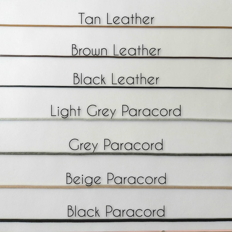 May include: A selection of cords in various colors, including tan, brown, and black leather, and light grey, grey, beige, and black paracord. Each cord is labeled with its respective color and material.