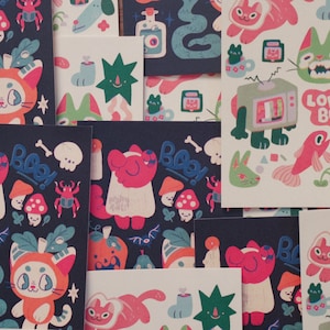 May include: A collection of colourful stickers featuring various illustrations, including cats, bugs, mushrooms, and other whimsical designs. The stickers are arranged in a grid pattern on a dark blue background. Some of the stickers have text, such as "Love Bug" and "Boo!"