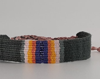 The "Rainbow Smith": Hand-woven bracelet, lichen green cotton, green/pale pink/yellow/orange/purple gradient, purple lurex thread in the center