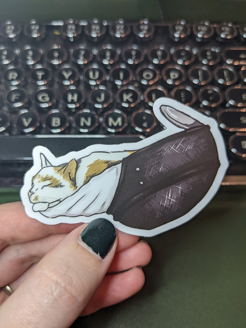 May include: A white and brown cat is sleeping inside a black and white patterned boot. The boot is curled up and the cat's head is resting on the top of the boot.