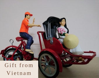 AO DAI non la Vietnam  conical hat Statue of Miss Vietnam sitting on a cyclo