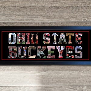 May include: A framed art piece with the words "OHIO STATE BUCKEYES" spelled out in a collage of images. The letters are filled with photos of football players and fans. The frame is black with a red border, set against a wood-grain background.