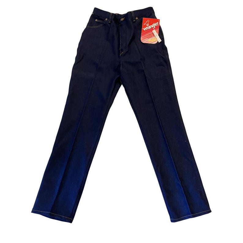 May include: Dark blue Wrangler jeans with a high waist and straight leg. The jeans have a classic five-pocket design, a zipper fly, and a Wrangler tag attached. The stitching is a contrasting yellow color.