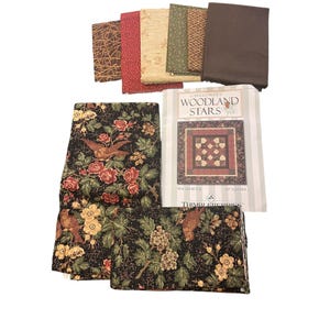 May include: A set of three ceramic mugs with a speckled, matte finish. The mugs are in shades of cream, light gray, and dark gray. Each mug has a simple, minimalist design and a rounded handle. The mugs are suitable for coffee, tea, or other beverages.