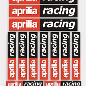 May include: A set of red and black stickers with the words "aprilia racing" repeated multiple times. The stickers are arranged in a grid pattern.