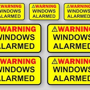 Op de afbeelding: Een verzameling gele rechthoekige waarschuwingsstickers met zwarte tekst die "WARNING WINDOWS ALARMED" luidt in een vet lettertype. Het woord "WARNING" is rood en een gele driehoek met een uitroepteken staat boven het woord.