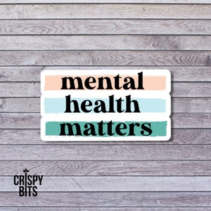 May include: A sticker with the text "mental health matters" in black letters on a white background. The text is divided into three lines with a peach, light blue, and teal colored stripe behind each line.