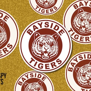 May include: Five round stickers with a white background and a red circle in the center. The red circle has a white tiger head with black stripes and the text "BAY SIDE TIGERS" in white around the circle.
