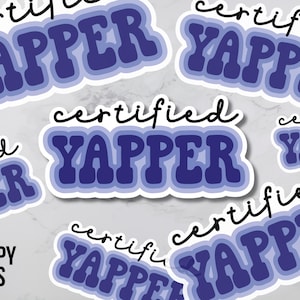 May include: Multiple stickers with the text "certified yapper" in a blue and white color scheme. The text is in a retro font style.
