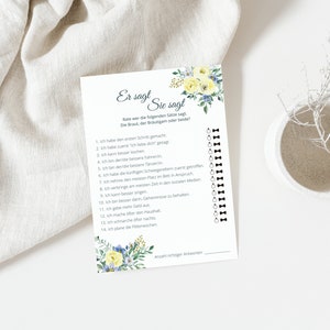 May include: A printable game card with a floral design and the text "Er sagt Sie sagt" in German. The card has a list of 14 statements with checkboxes next to each statement.