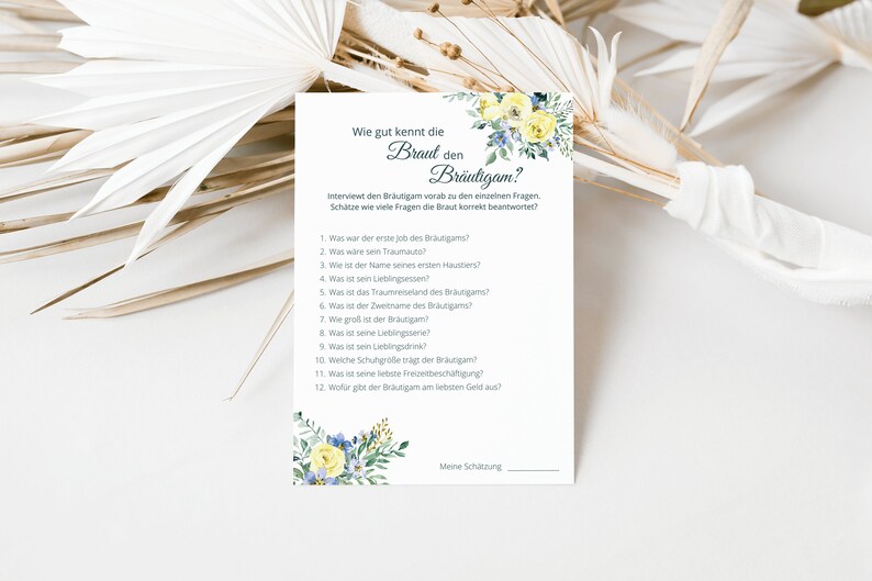 May include: A printable game card with a floral design and the text "Wie gut kennt die Braut den Br&auml;utigam?"  The card includes a list of questions to ask the groom about the bride.